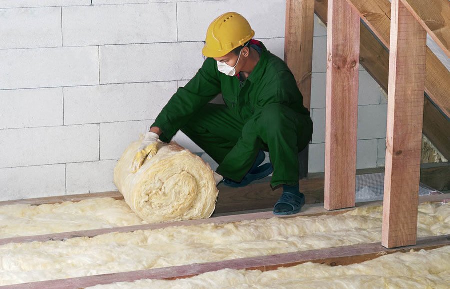 About Us - Man unrolling and installing roof insulation for Mr Insulation in Perth
